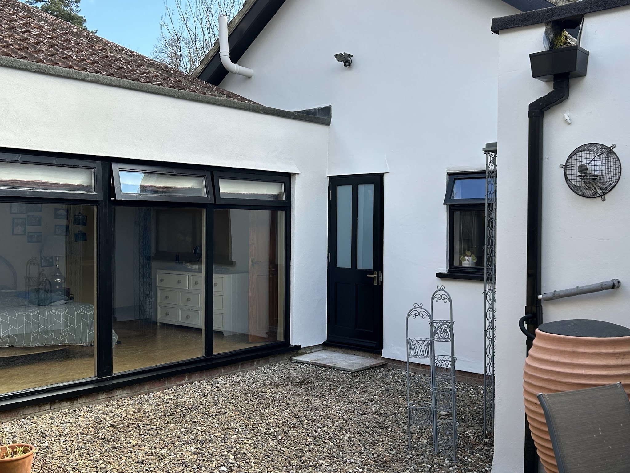 White rendered courtyard with black framed glazing