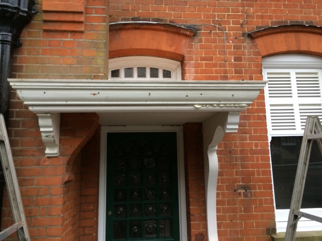 Victorian door canopy and brackets repainted white