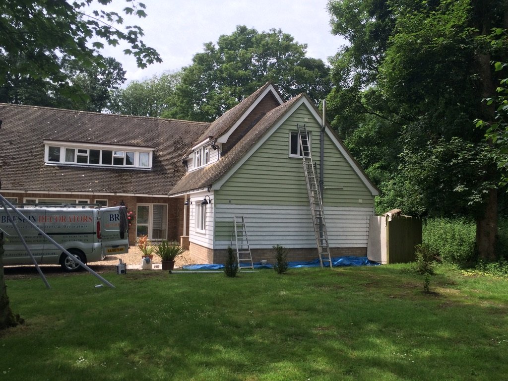 Sage green weatherboarded gable repainted