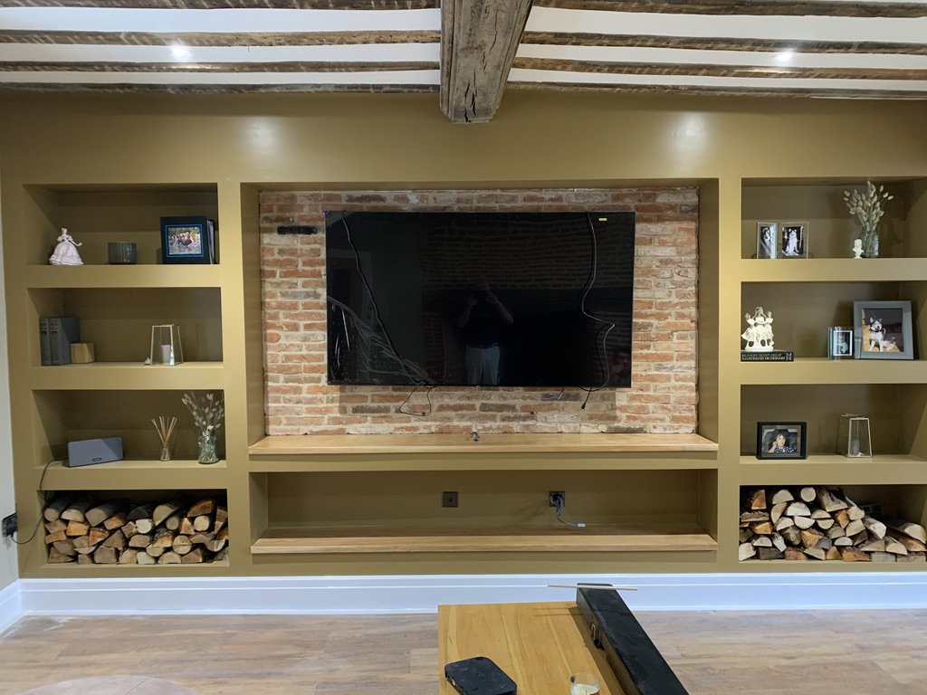 Media wall with brick slips and alcove shelving