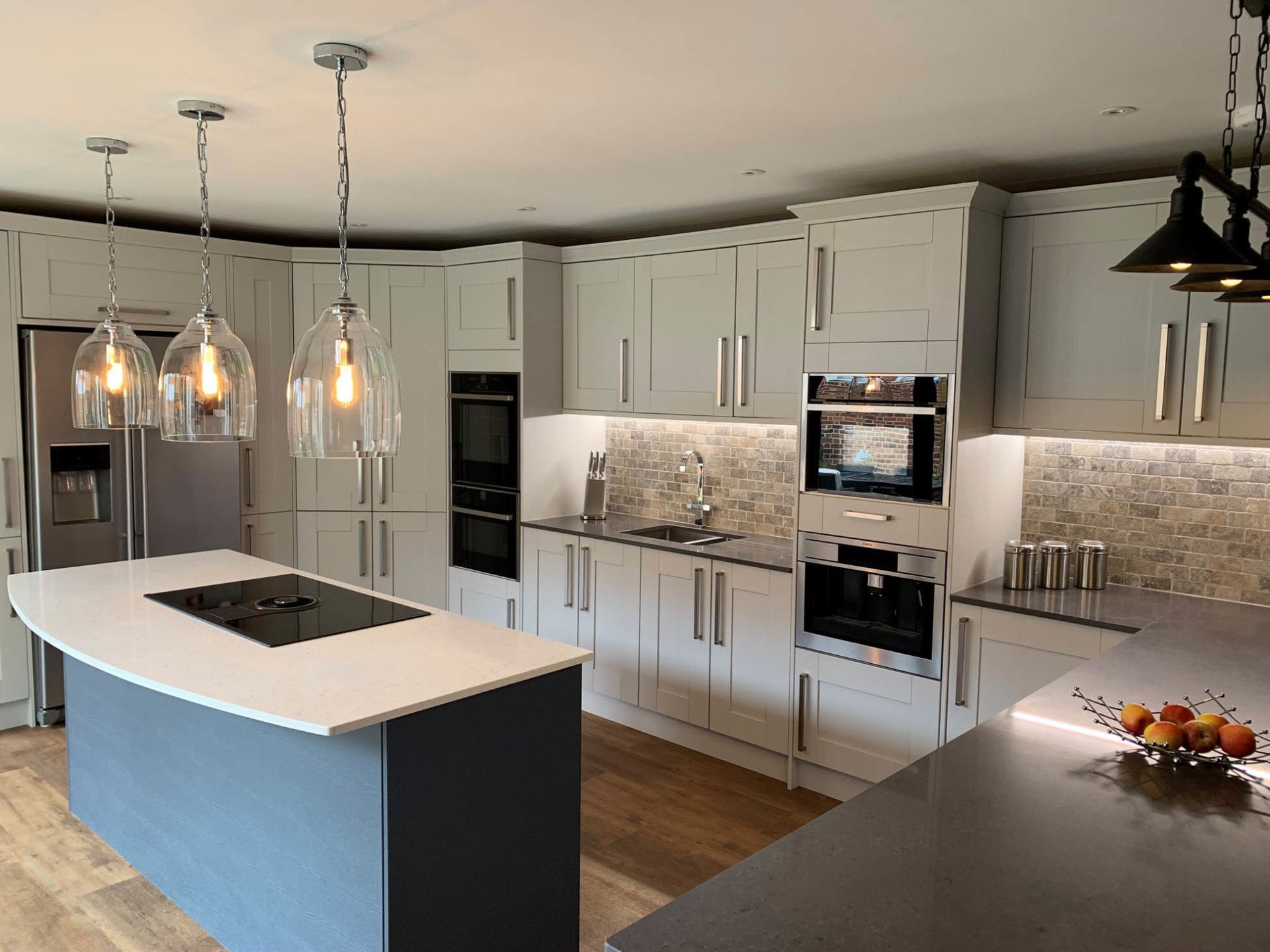 Shaker style kitchen with an island and pendant lights